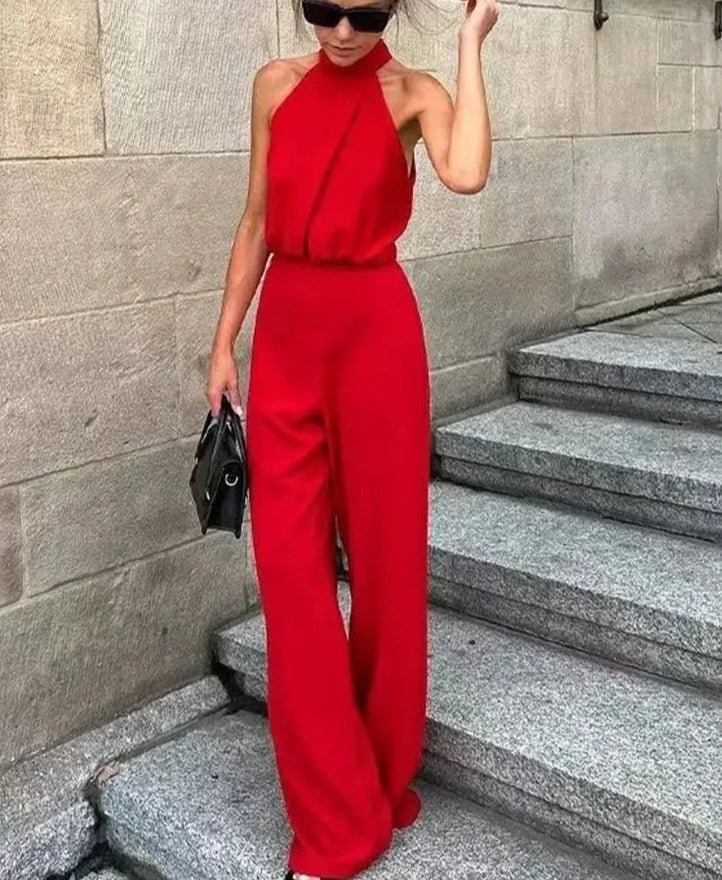 Woman wearing red halter neck jumpsuit with high waist