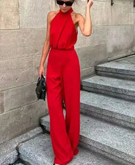 Woman wearing red halter neck jumpsuit with high waist