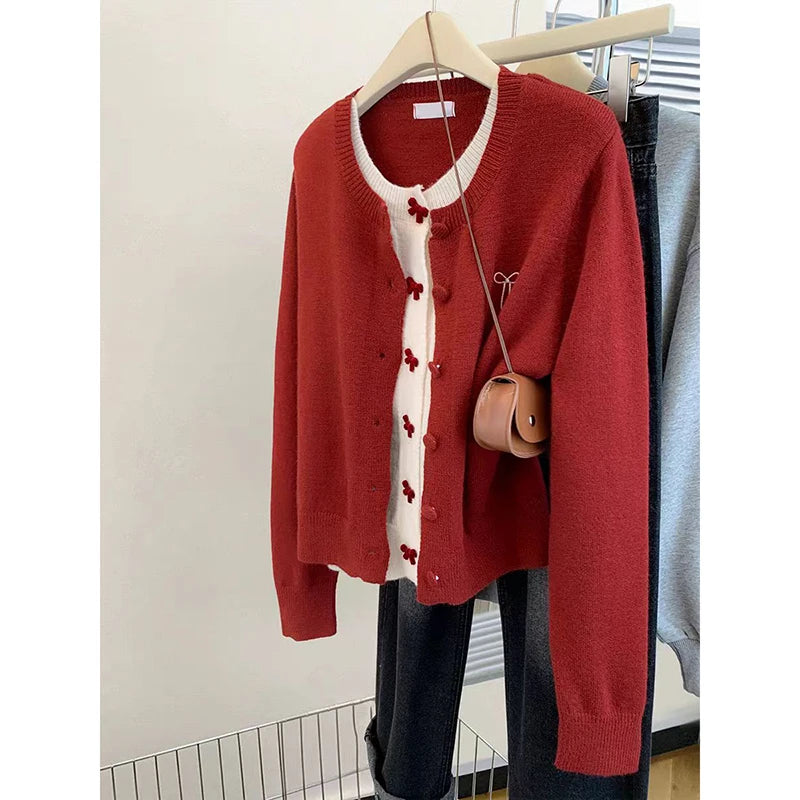 Red patchwork knit cardigan with white placket on hanger