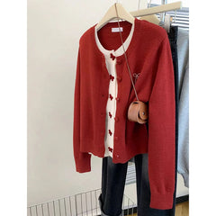 Red patchwork knit cardigan with white placket on hanger