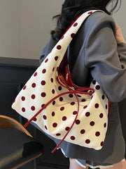 Red polka dot bow tote bag styled for playful summer days