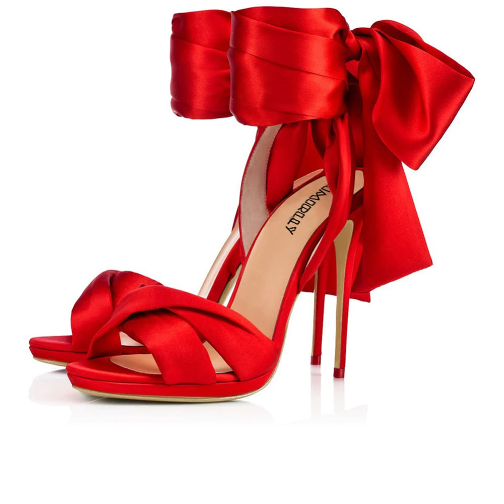 Red satin bow high heels with wrap tie ankle ribbons styled for parties