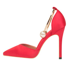 A  red high heels with pearl metal buckles and open-toe platforms, displayed on a bubble bag outsole side view.