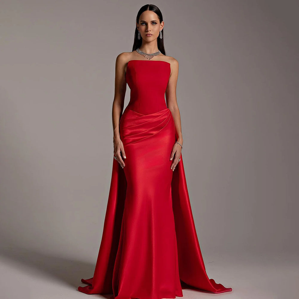 Red strapless satin mermaid gown with draped overskirt on model