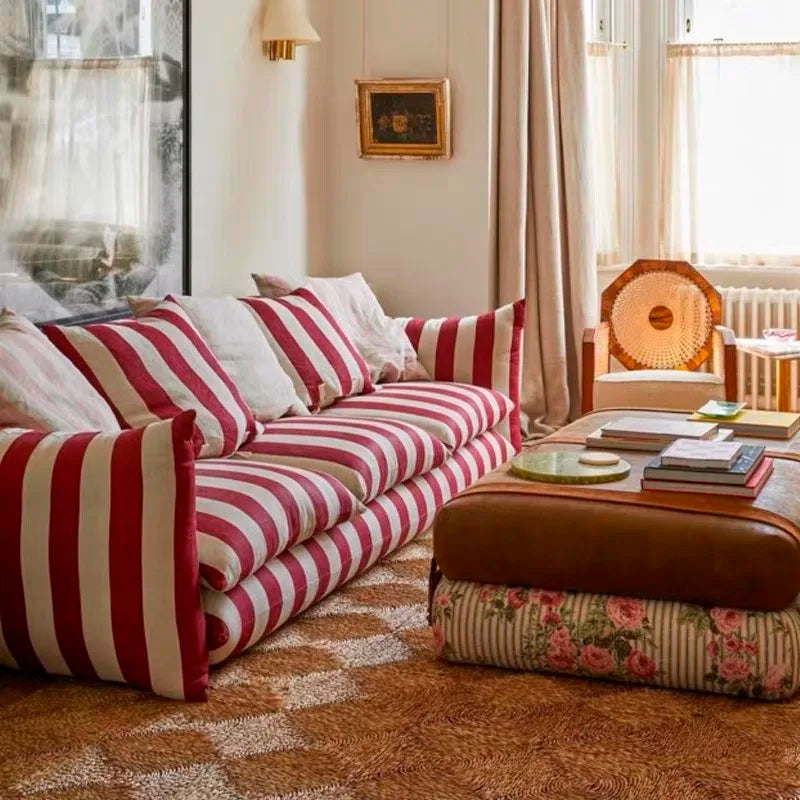 “Red and white striped fabric sofa in modern art-style living room”