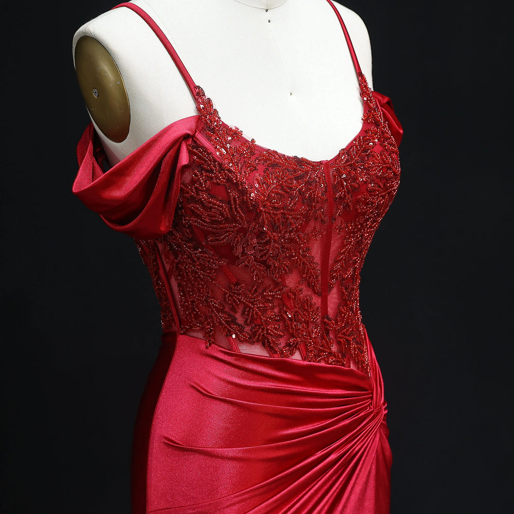 Red evening gown on a mannequin against a black background