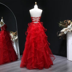 Back view of a backless A-line gown with airy layered ruffles