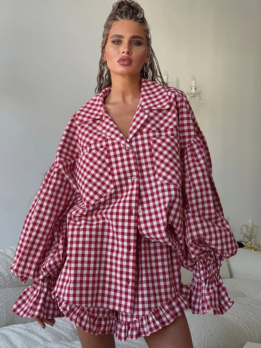 Woman wearing a red and white checkered shirt with ruffled sleeves and hem and shorts set