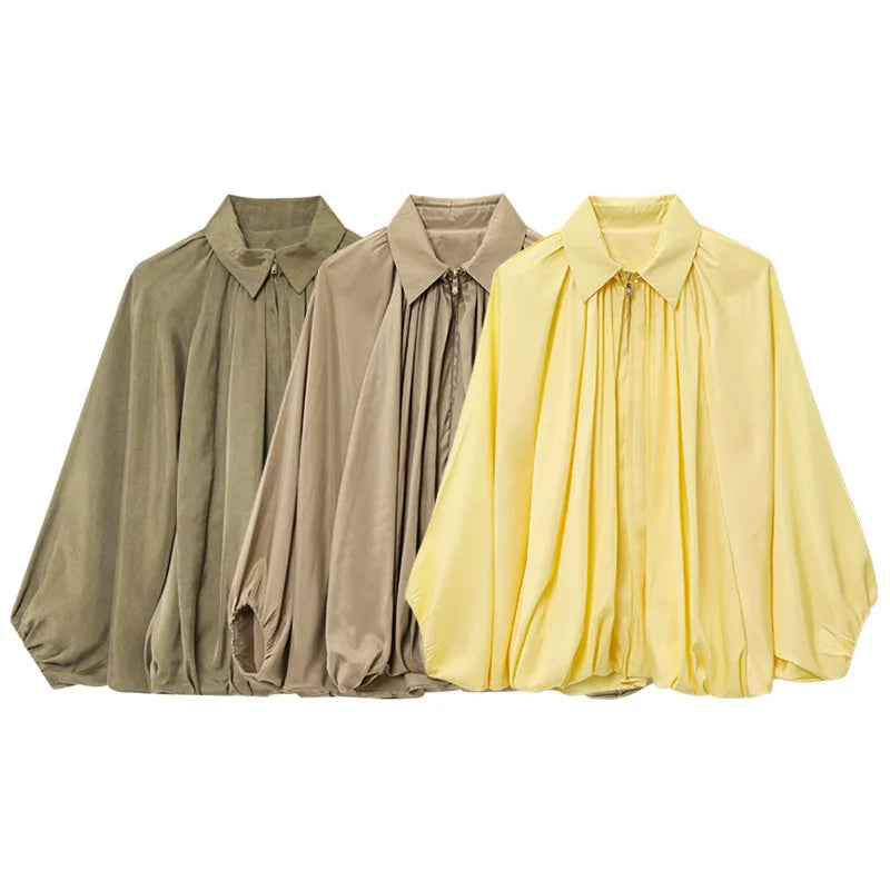 Three shirts in green, beige, and yellow on a white background