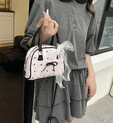 Elegant black and white bow print shoulder bag