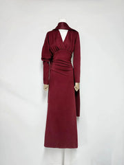 Side profile of a satin maxi dress with draped waist and long sleeves.