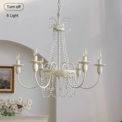 Romantic bedroom with French country chandelier and crystal drapes