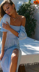 Details of blue puff short sleeves and an empire waist on a beach-style women's dress