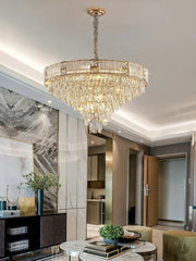 Round drum crystal pendant chandelier above a sofa and table