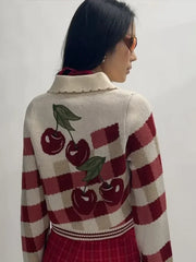 Close view of cherry embroidery detail on a knit cardigan