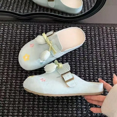 Close-up of lace-up flower design on women’s round toe slides