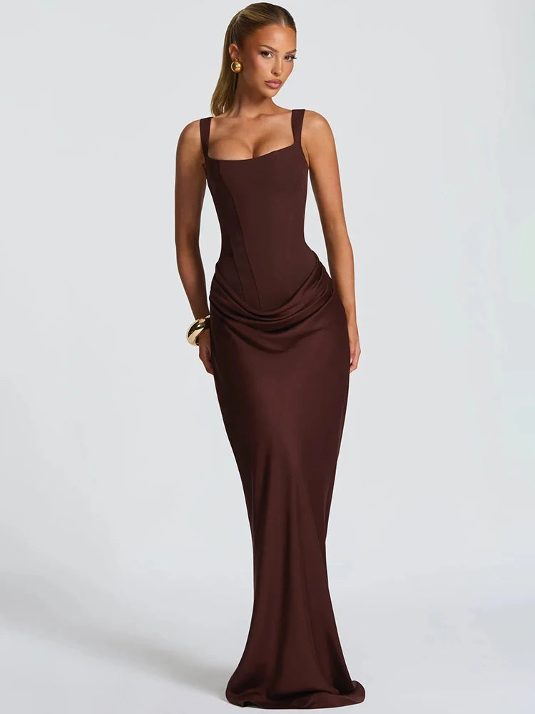 Ruched square collar maxi dress with tapered straps shown in a studio setting, highlighting the sculpted waist and elongated silhouette.