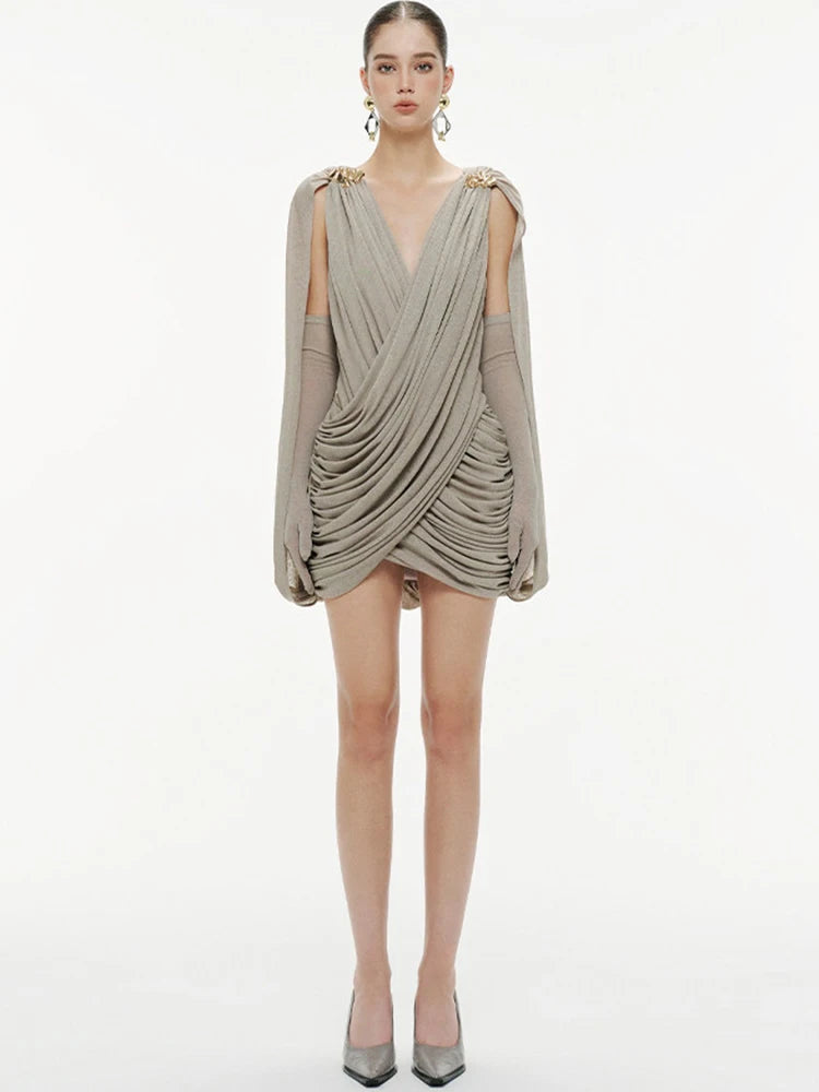 Detail of the ruched drape through the waist and hips, creating flattering contouring and elegant texture in a slim mini silhouette.