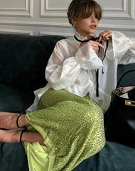 Woman wearing white ruffle collar long sleeve blouse