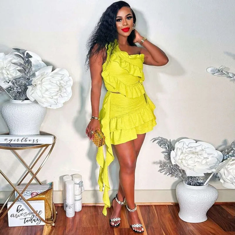 Woman wearing yellow ruffle one-shoulder top and mini skirt set