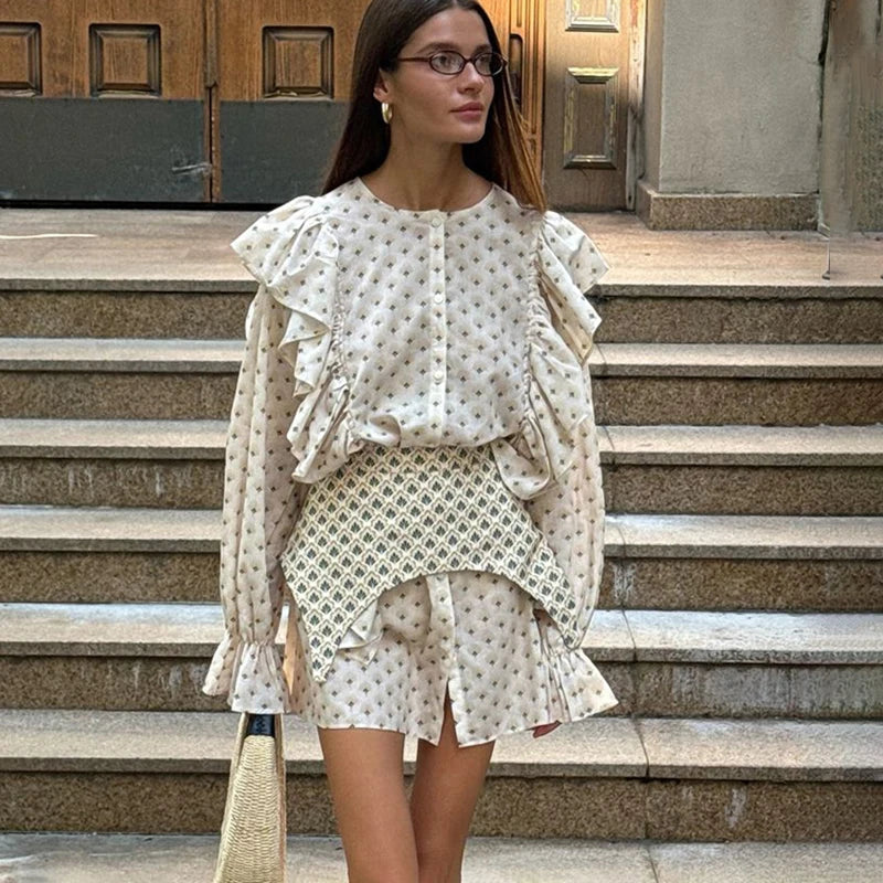 Front view of floral ruffled mini dress with waist seal and buttoned top