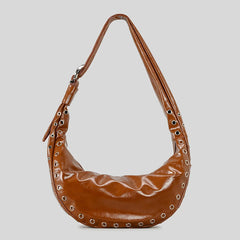 Runway inspired rivet bag in soft brown shown underarm