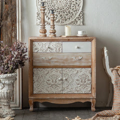 “Rustic carved wood cabinet with whitewashed floral doors in living room”