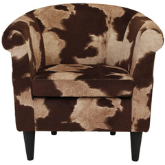 Rustic modern cow print lounge chair in a contemporary home setting