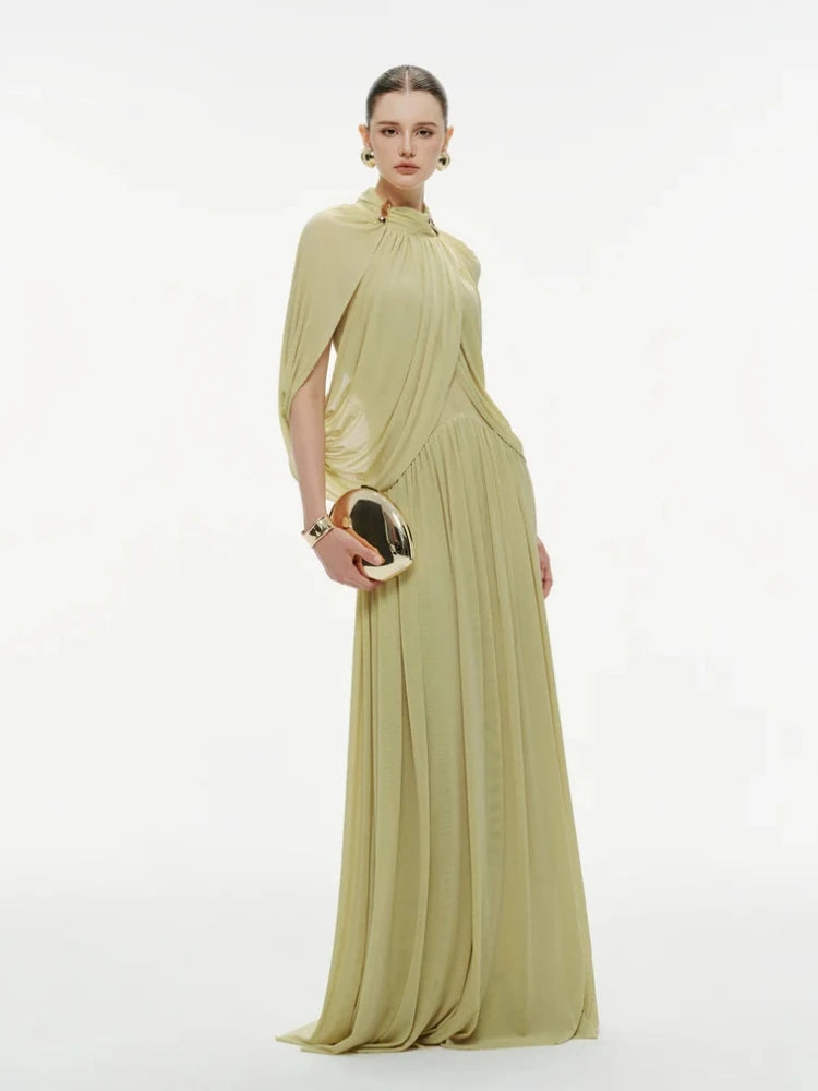 Full-length front view highlighting the ruched waist shaping and the flowing cape-style overlay that falls smoothly over the arms.