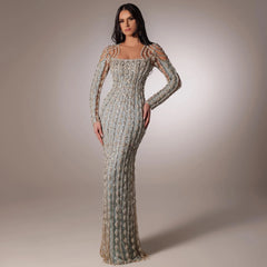 Sage green beaded mermaid evening dress styled for Dubai weddings with intricate detailing on a neutral background