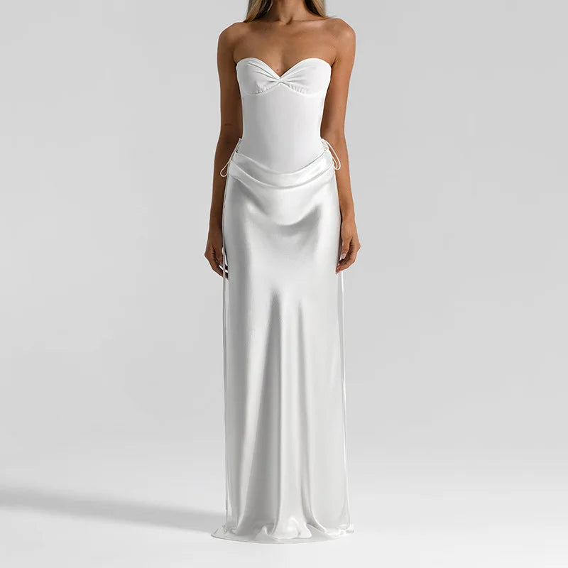 Strapless satin maxi dress in a streamlined fit, styled with minimal accessories for a refined evening look and clean neckline focus.