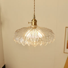 A hanging ceiling light with a transparent glass shade designed to resemble a flower, with a visible bulb and a metallic gold finish.