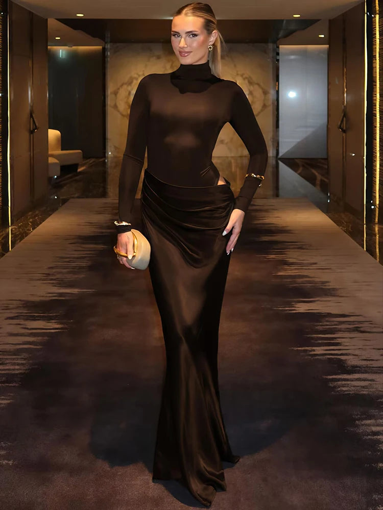 Woman in a floor-length sculpted gown, perfect for winter events, standing in an elegant interior setting