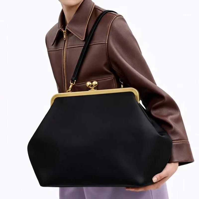 Close-up of clip-top detailing and structured fold design on clutch