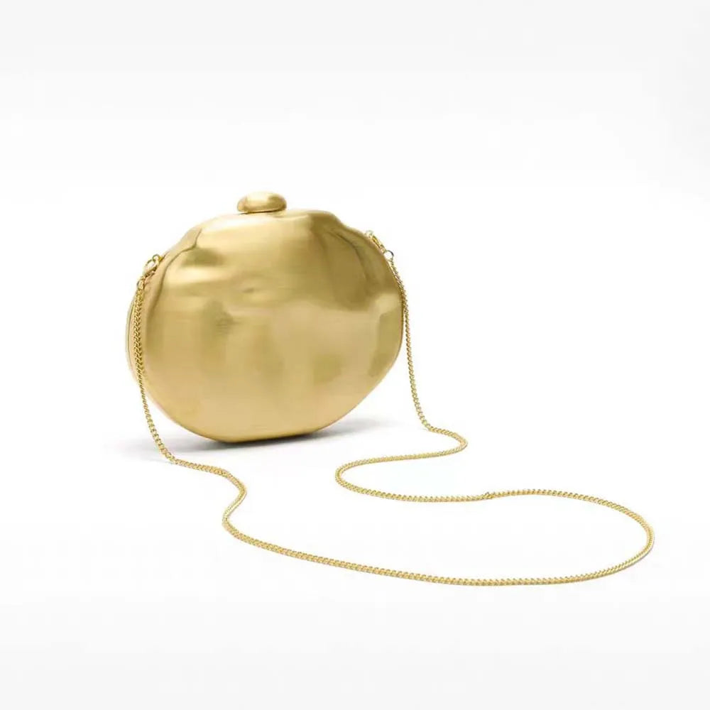 Sculptural gold round clutch bag with fine chain for evening