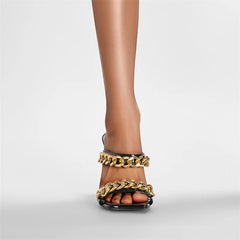 Close-up of the gold sculptural heel and spiked-inspired base detail, showing the dramatic shape and glossy finish.