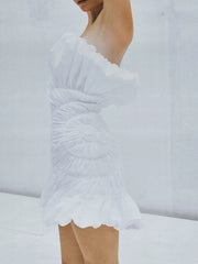 Structured strapless white dress with shell-inspired design
