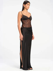Woman wearing a see through bodycon formal dress in black paired with event accessories  on a white background