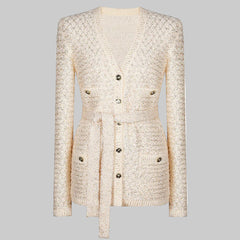 Front view of a beige textured knit coat with a waist tie and button details, presented cleanly against a studio background.