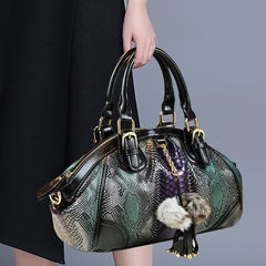 Serpentine animal motif handbag with tassel accent