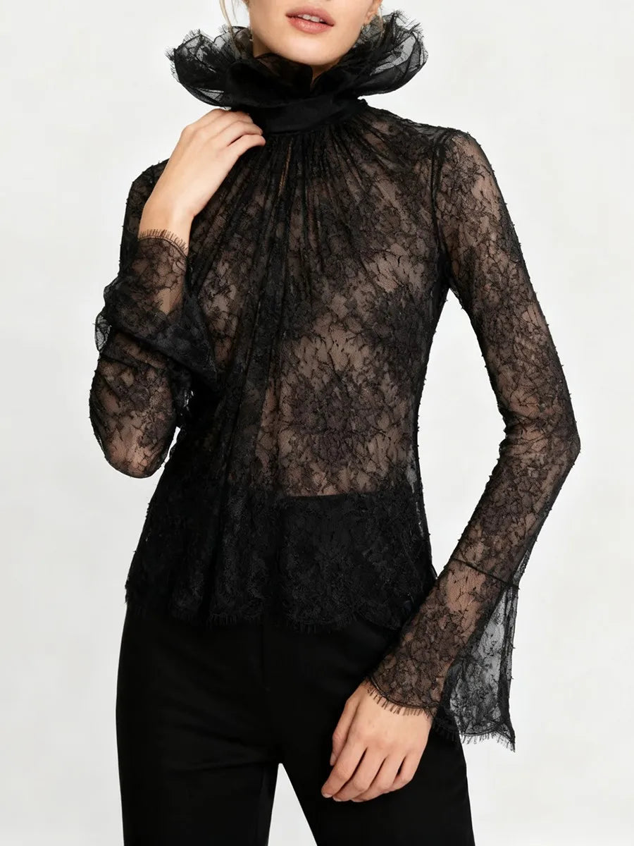 Full-length view of the lace top tucked into high-waisted trousers, highlighting the slim silhouette and detailed neckline.