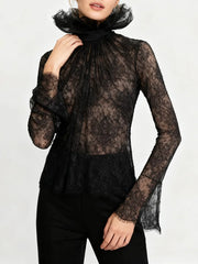 Full-length view of the lace top tucked into high-waisted trousers, highlighting the slim silhouette and detailed neckline.