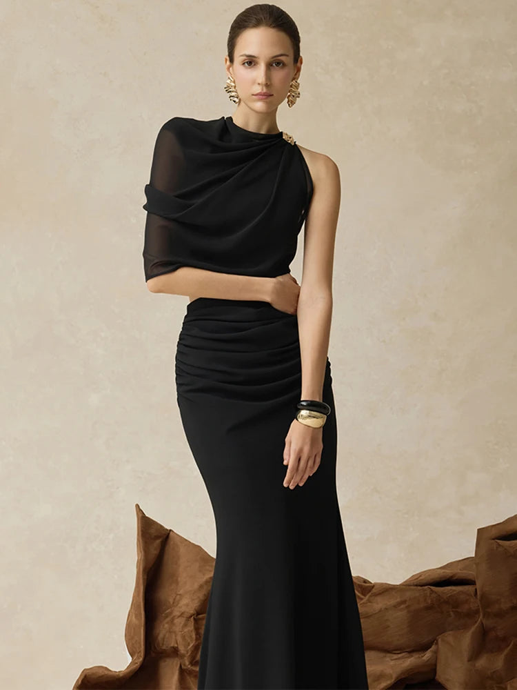 Close-up of the one-shoulder neckline and sheer sleeve, showing soft transparency and clean draping across the bodice.