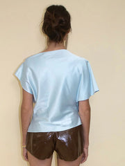 The back view of the elegant satin top, showing its fit and fabric.
