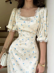 Side angle of puff sleeve floral dress with curved fit and waist tie
