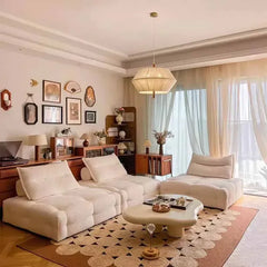 “Side view of low-profile lounge couch with soft upholstery and wooden base”