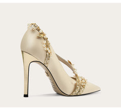 Close-up of silk pointed toe pumps with pearl belt