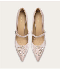 a silk pump with pearls, rhinestones, and a thin heel.