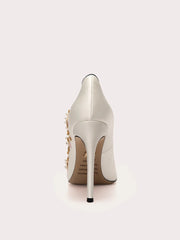 Close-up of silk pearl embroidered stiletto shoes