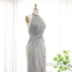 Floor-length trumpet gown with feather detailing and sequin finish